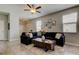 Living room featuring large couch, area rug, and natural lighting at 4023 Wild Senna Blvd, Tampa, FL 33619