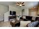 View of the living room with tile flooring, large couch, and a mounted TV at 4023 Wild Senna Blvd, Tampa, FL 33619