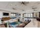 Large recreation room with leather sofas, billiards table, and multiple ceiling fans at 4023 Wild Senna Blvd, Tampa, FL 33619