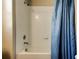 Shower and tub with a blue curtain and white tiled walls at 4023 Wild Senna Blvd, Tampa, FL 33619
