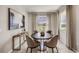Cozy dining area with a modern table set and natural light from the window at 4026 Harvest Hearth Pl, Plant City, FL 33565