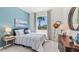 Serene bedroom with a blue accent wall, stylish furnishings, and ample natural light at 4031 Westwood Fields Loop, Plant City, FL 33565