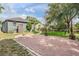 Backyard features brick patio with fire pit and a brick path to a backyard area at 4205 N Suwanee Ave, Tampa, FL 33603