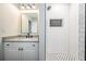 Updated bathroom featuring a single sink vanity and a subway tile shower with a toiletry niche at 4205 N Suwanee Ave, Tampa, FL 33603