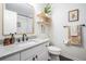 Bright bathroom features a single sink vanity, gray countertop, and a subway tile shower at 4205 N Suwanee Ave, Tampa, FL 33603