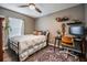 Cozy bedroom with a full bed, desk, shelving and a ceiling fan at 4205 N Suwanee Ave, Tampa, FL 33603
