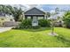 Charming home with a well-manicured front yard and lush landscaping on a bright, sunny day at 4205 N Suwanee Ave, Tampa, FL 33603
