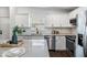 Stylish kitchen featuring white cabinets, stainless steel appliances, and a sleek countertop at 4205 N Suwanee Ave, Tampa, FL 33603
