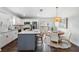 Modern eat-in kitchen features stainless steel appliances and a center island with bar stool seating at 4205 N Suwanee Ave, Tampa, FL 33603