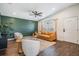 Cozy living room with stylish furniture, including a leather sofa and plush chairs over hardwood floors at 4205 N Suwanee Ave, Tampa, FL 33603