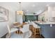 Spacious open-concept living space features a kitchen with seating, dining area, and cozy living room at 4205 N Suwanee Ave, Tampa, FL 33603