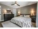 Serene primary bedroom featuring a decorative ceiling fan, a dresser, and a bedside table at 4205 N Suwanee Ave, Tampa, FL 33603