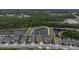 Community aerial view of the property situated near a pond in a residential neighborhood at 4239 Woodland Retreat Blvd, New Port Richey, FL 34655