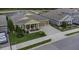 Beautiful house with a manicured lawn and a pond view at 4239 Woodland Retreat Blvd, New Port Richey, FL 34655