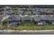 Aerial view of the back of the property, featuring a spacious yard and serene pond views at 4239 Woodland Retreat Blvd, New Port Richey, FL 34655