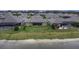 Aerial view of the back of the property, showcasing a spacious yard with serene lake views at 4239 Woodland Retreat Blvd, New Port Richey, FL 34655