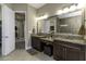 Bathroom featuring double sinks with granite countertops, leading to the water closet and shower at 4239 Woodland Retreat Blvd, New Port Richey, FL 34655