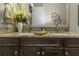 Bathroom features granite counters, dual sinks, modern fixtures, and decorative accents at 4239 Woodland Retreat Blvd, New Port Richey, FL 34655
