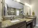 Bathroom featuring double sinks, granite countertops, and a walk-in shower with a glass enclosure at 4239 Woodland Retreat Blvd, New Port Richey, FL 34655