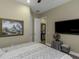 The bedroom features a TV, full bed, decorative artwork, and carpeted floors at 4239 Woodland Retreat Blvd, New Port Richey, FL 34655