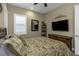 Cozy bedroom with ceiling fan, plantation shutters, and tropical bedding, offering a tranquil retreat at 4239 Woodland Retreat Blvd, New Port Richey, FL 34655