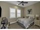 Cozy bedroom featuring carpet, white windows, fan, Queen bed, and side table at 4239 Woodland Retreat Blvd, New Port Richey, FL 34655