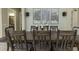 Elegant dining room with seating for eight, enhanced by stylish wall art and sophisticated lighting at 4239 Woodland Retreat Blvd, New Port Richey, FL 34655