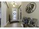 Inviting foyer with decorative light fixture, tile flooring, and transom window at 4239 Woodland Retreat Blvd, New Port Richey, FL 34655