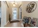 Bright foyer with tile flooring, decorative art, and glass-paneled front door at 4239 Woodland Retreat Blvd, New Port Richey, FL 34655