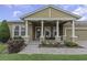 Inviting covered porch with stone pillars and comfortable seating area at 4239 Woodland Retreat Blvd, New Port Richey, FL 34655
