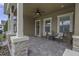 Welcoming front porch featuring stone accents, seating, and ceiling fan at 4239 Woodland Retreat Blvd, New Port Richey, FL 34655