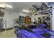 Well-organized garage space featuring multiple cars, storage solutions, and overhead lighting at 4239 Woodland Retreat Blvd, New Port Richey, FL 34655
