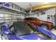 Well-organized garage with car, kayak, bicycle, and overhead storage racks at 4239 Woodland Retreat Blvd, New Port Richey, FL 34655