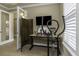 Home office space with exercise equipment and work bench at 4239 Woodland Retreat Blvd, New Port Richey, FL 34655