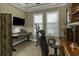 Home office with a workspace area, exercise equipment and natural lighting at 4239 Woodland Retreat Blvd, New Port Richey, FL 34655