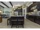 Spacious kitchen with dark cabinets, stainless steel appliances, central island with seating, and open layout at 4239 Woodland Retreat Blvd, New Port Richey, FL 34655