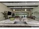 Modern kitchen island with granite countertop, sink, and open living space at 4239 Woodland Retreat Blvd, New Port Richey, FL 34655
