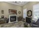 Inviting living room with fireplace, plantation shutters, and comfortable seating at 4239 Woodland Retreat Blvd, New Port Richey, FL 34655