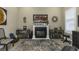 Cozy living room featuring a fireplace, decorative accents, and a bright window at 4239 Woodland Retreat Blvd, New Port Richey, FL 34655