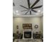 Cozy living room featuring a fireplace, decorative accents, and a bright ceiling fan at 4239 Woodland Retreat Blvd, New Port Richey, FL 34655