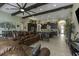 Expansive open-concept living area featuring a gourmet kitchen, dining space, and comfortable seating, all with elegant design at 4239 Woodland Retreat Blvd, New Port Richey, FL 34655