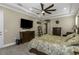 Spacious main bedroom with a large TV and neutral tones, creating a comfortable retreat at 4239 Woodland Retreat Blvd, New Port Richey, FL 34655