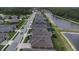 Neighborhood street view showcasing the property's location within a well-maintained community near a large pond at 4239 Woodland Retreat Blvd, New Port Richey, FL 34655