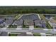 Overhead view of a home located on a street near a pond with other similar neighborhood properties at 4239 Woodland Retreat Blvd, New Port Richey, FL 34655