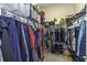 Organized walk-in closet with shelving and rods for ample storage of clothes and accessories at 4239 Woodland Retreat Blvd, New Port Richey, FL 34655