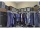 Walk-in closet featuring ample storage with wire shelving, hanging rods, and floor-to-ceiling organization at 4239 Woodland Retreat Blvd, New Port Richey, FL 34655
