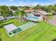 Overhead view of the community pool and shuffleboard courts on grass at 4309 Cedar Grove St, Holiday, FL 34691