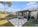 Backyard featuring a tiled patio, grass and partial fence at 4309 Cedar Grove St, Holiday, FL 34691