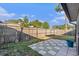 Backyard showing a tiled patio and grass, surrounded by a wooden fence at 4309 Cedar Grove St, Holiday, FL 34691