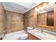 Well-lit bathroom with a shower-tub combo and granite countertop sink at 4309 Cedar Grove St, Holiday, FL 34691